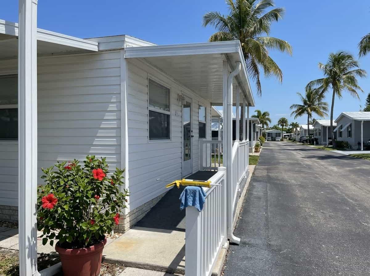 Well-kept home with an awning on a narrow lane in Briny Breezes, FL