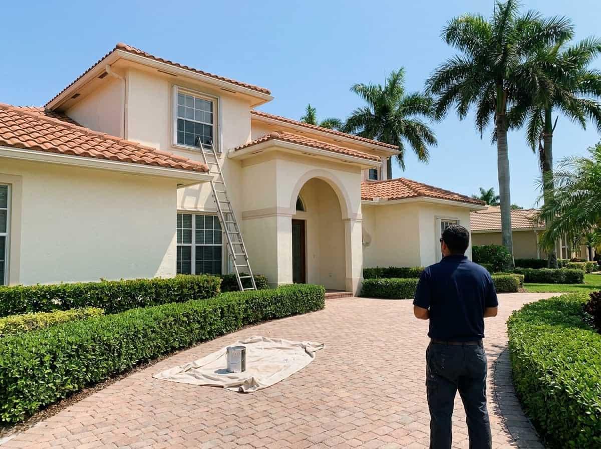 Exterior painting prep on a two-story home in Royal Palm Beach, FL