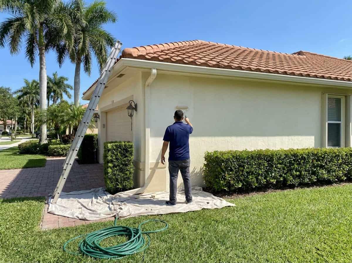 Exterior stucco painting on a single-story home in Palm Beach County, FL