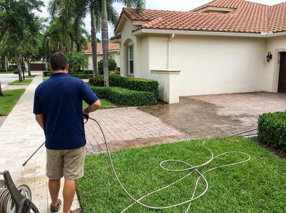 Paver driveway being pressure washed at a home in Palm Beach County, FL
