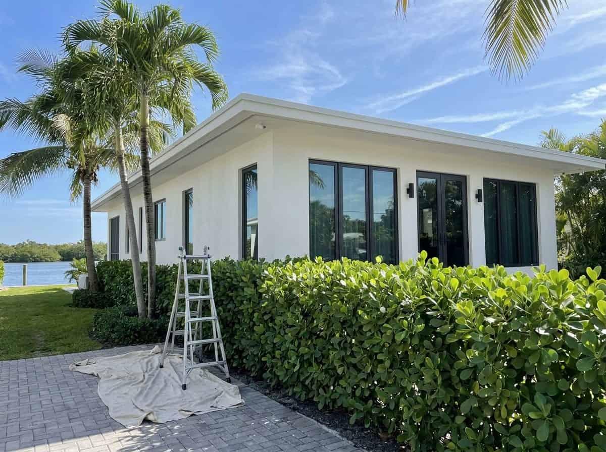 Coastal home with a ladder set up for exterior work in Ocean Ridge, FL