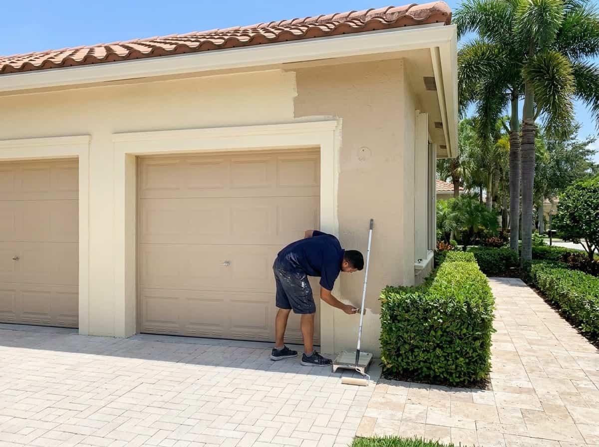 Garage door and stucco wall being repainted in Palm Beach County, FL