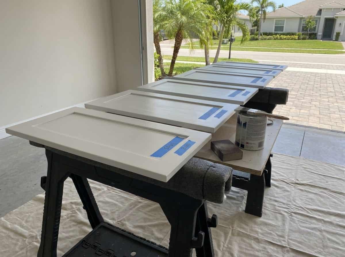Cabinet doors being refinished in a garage in Palm Beach County, FL