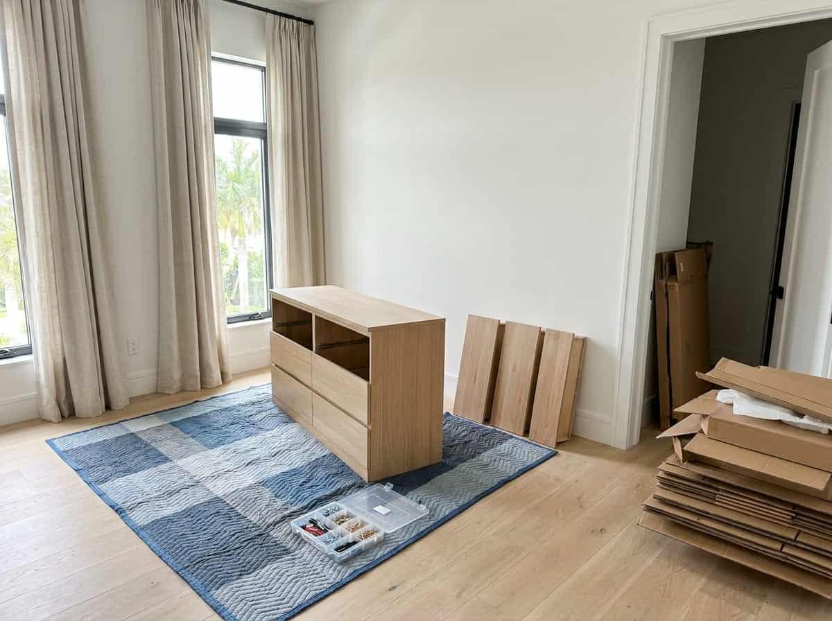 Flat pack dresser being assembled in a bedroom in Palm Beach County, FL